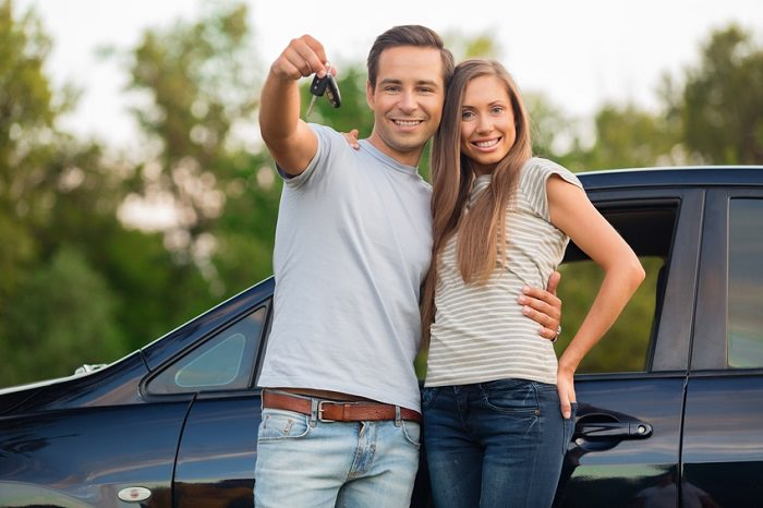 Happy Couple Next to Car